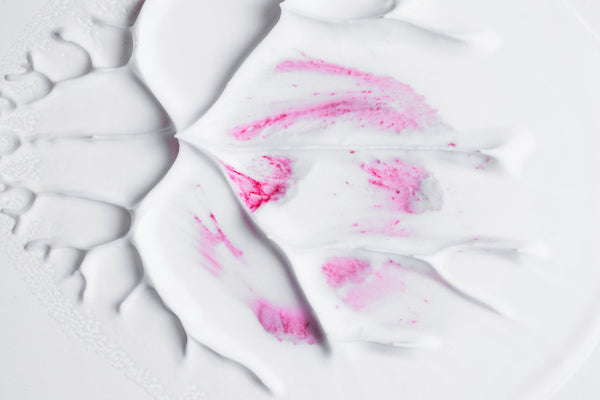 White Skin Care Cream with pink highlights