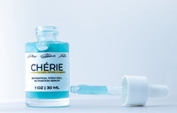 Chérie botanical stem cell activation serum bottle with dropper on a light blue background